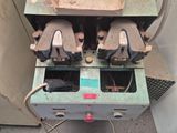 a machine that is sitting on the ground next to a wall
