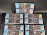 six boxes of coins are stacked on top of each other on a table