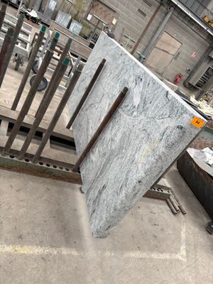a pile of marble on the ground in a warehouse