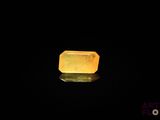 an image of a yellow quartz stone on a black surface