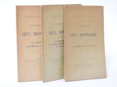 three books sitting on top of each other on a white surface