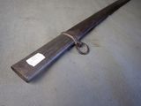 a long wooden stick with a tag on it