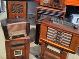 many old radio ' s sitting on the floor in a room