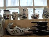 many vases and bowls on the counter in this kitchen