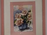 a picture of a painting of roses in a vase on the wall
