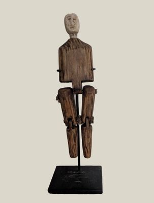 statue of a man with a wooden head and legs