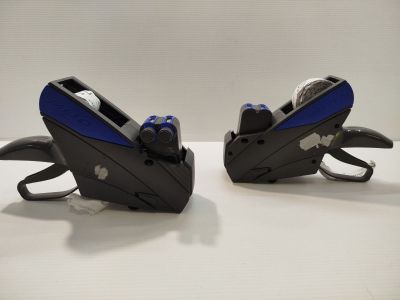two black and blue staplers on a white table