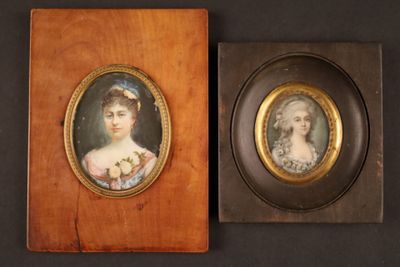 pair of miniature portraits of women in oval frames on a black background