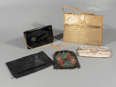 four purses and a handbag sitting on a table