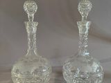pair of clear glass decanters on a white background