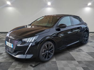 the black car is parked on a checkered floor in the garage