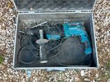 a tool in a case that is sitting on the ground
