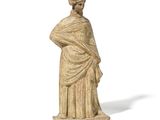 an old statue of a woman standing with her hands on her hips