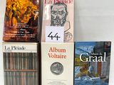 several books are stacked on top of each other on a table