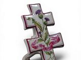 purple and white cross with flowers on it on a white background