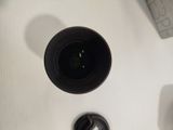 a camera lens sitting on top of a table next to a keyboard