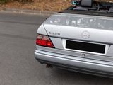 a silver car that is parked on the side of the road