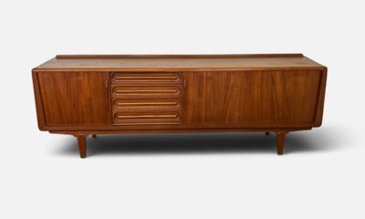 the sideboard is made of wood and has four drawers