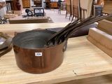 a lot of pots and pans sitting on a table