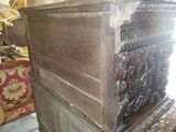 a wooden chest with carvings on it in a room