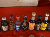 many bottles of alcohol lined up on a red table