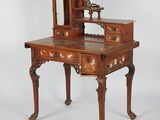 a small wooden desk with a mirror on top of it