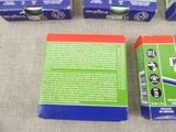 three boxes of toothpaste sitting on top of a table next to a box of toothpaste