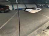 a reflection of a boat in the side mirror of a car