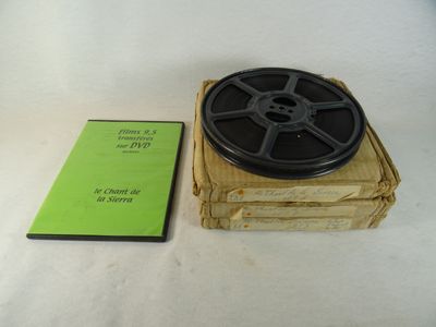 une bobine de film posée sur une boîte à côté d'un livre