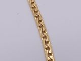a close up of a gold chain on a white surface