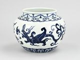 a blue and white vase with a dragon on it