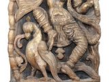 sculpture of a man and a woman playing with a dog