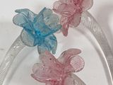 three flowers that are sitting on top of a table