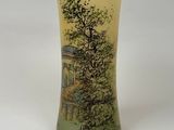 a vase that has a picture of a house on it