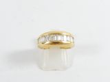 a yellow gold ring with baguets of diamonds