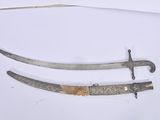 two swords that are laying on a white surface