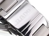 a close up of a watch on a white surface