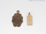 an image of a small bronze medal and a tag on a white surface