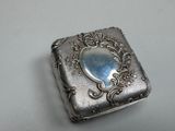 a silver box with a mirror on it on a table