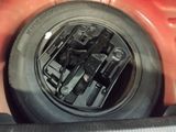 a close up of a car ' s tire with a bunch of screws in it