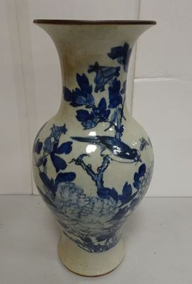 a blue and white vase with a bird on it