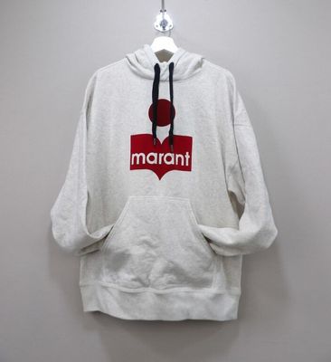 the hoodie is hanging on a hanger on the wall