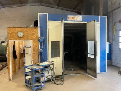 a picture of a room with a door open and a table in the middle of the room