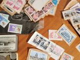 a suitcase full of stamps and money on a table