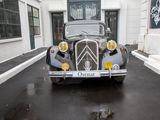 an old car parked on the side of the street