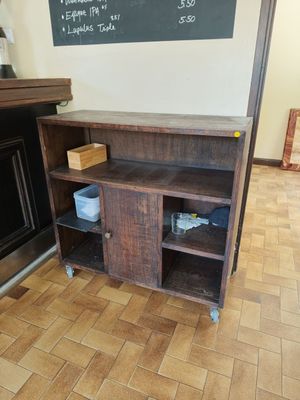 a blackboard on the wall above a wooden entertainment center