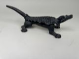 a small black cat figurine on a white surface
