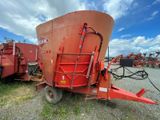 a red grainer that is sitting in the grass