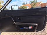 a picture of a car door with the door handle open