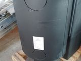 a black tank sitting on a pallet in a garage